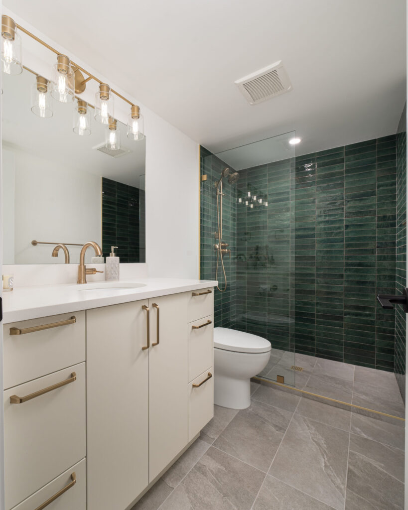 Bathroom renovation with glass shower enclosure and tile flooring