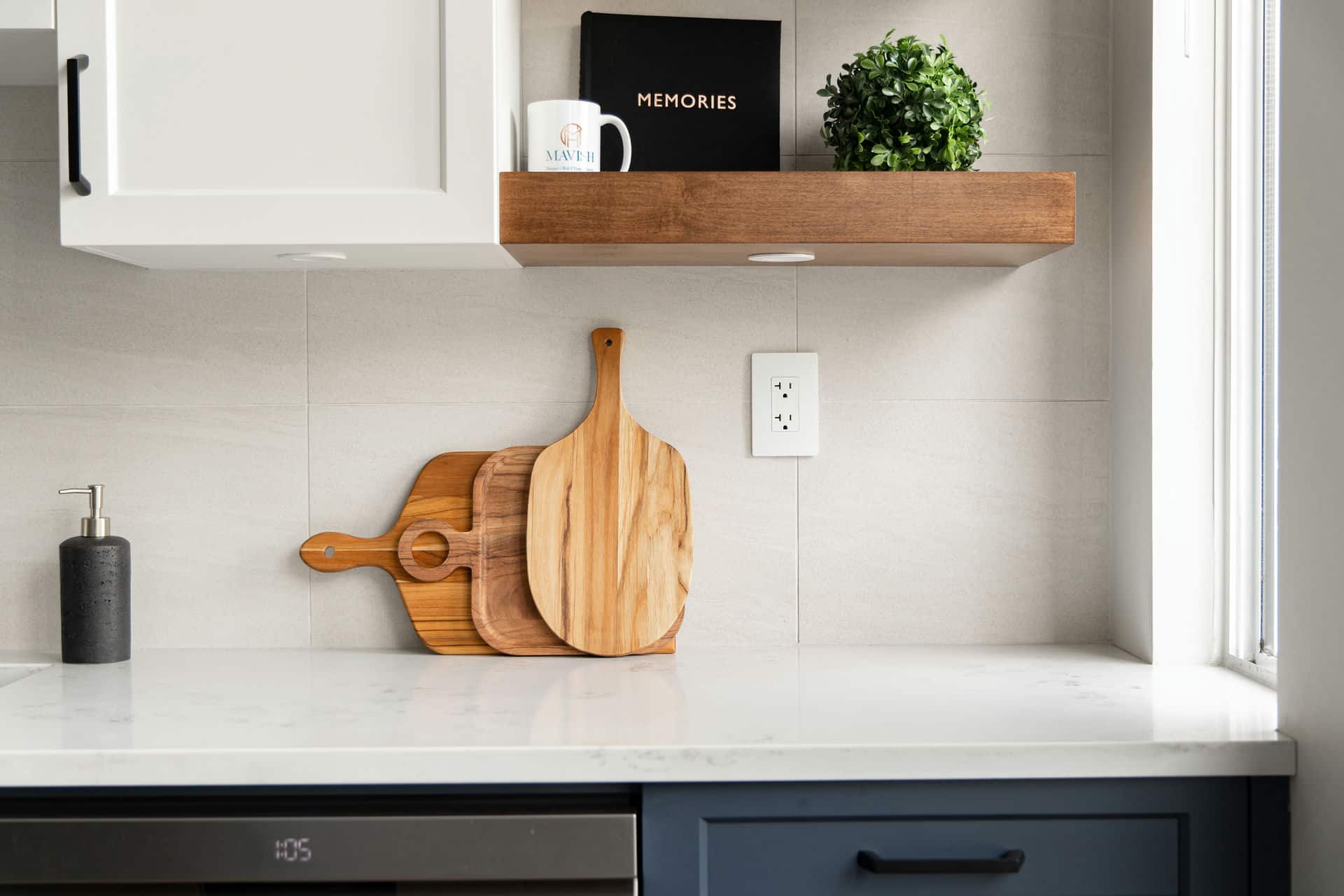 Kitchen counter with wooden cutting board and floating shelves – modern renovation