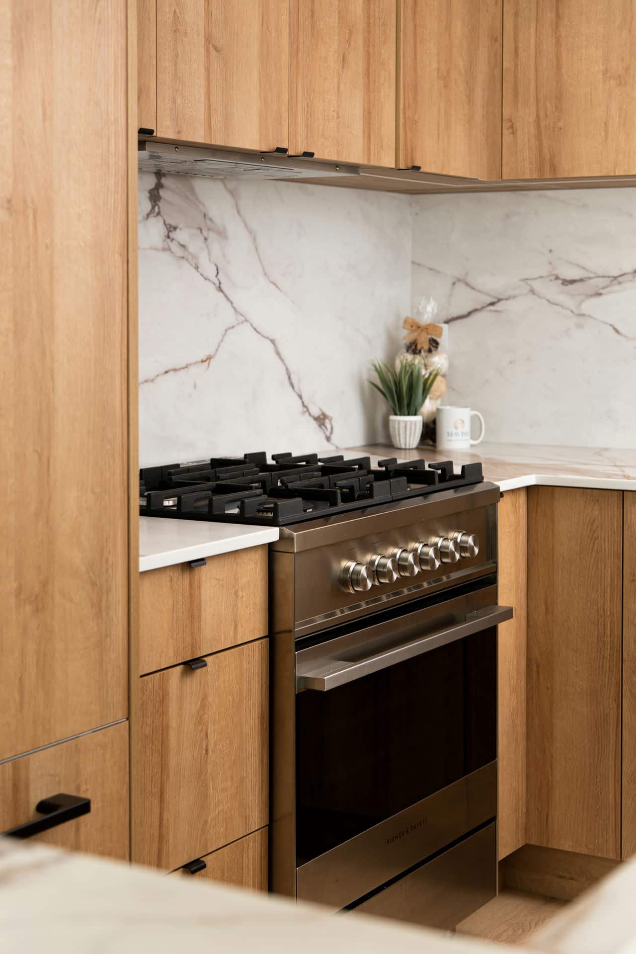 Close-up of kitchen stove with wooden cabinetry – home renovation detail