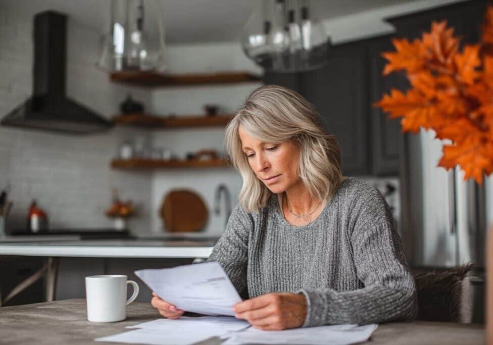 Homeowner reviewing custom home contract payment schedule and checklist in BC